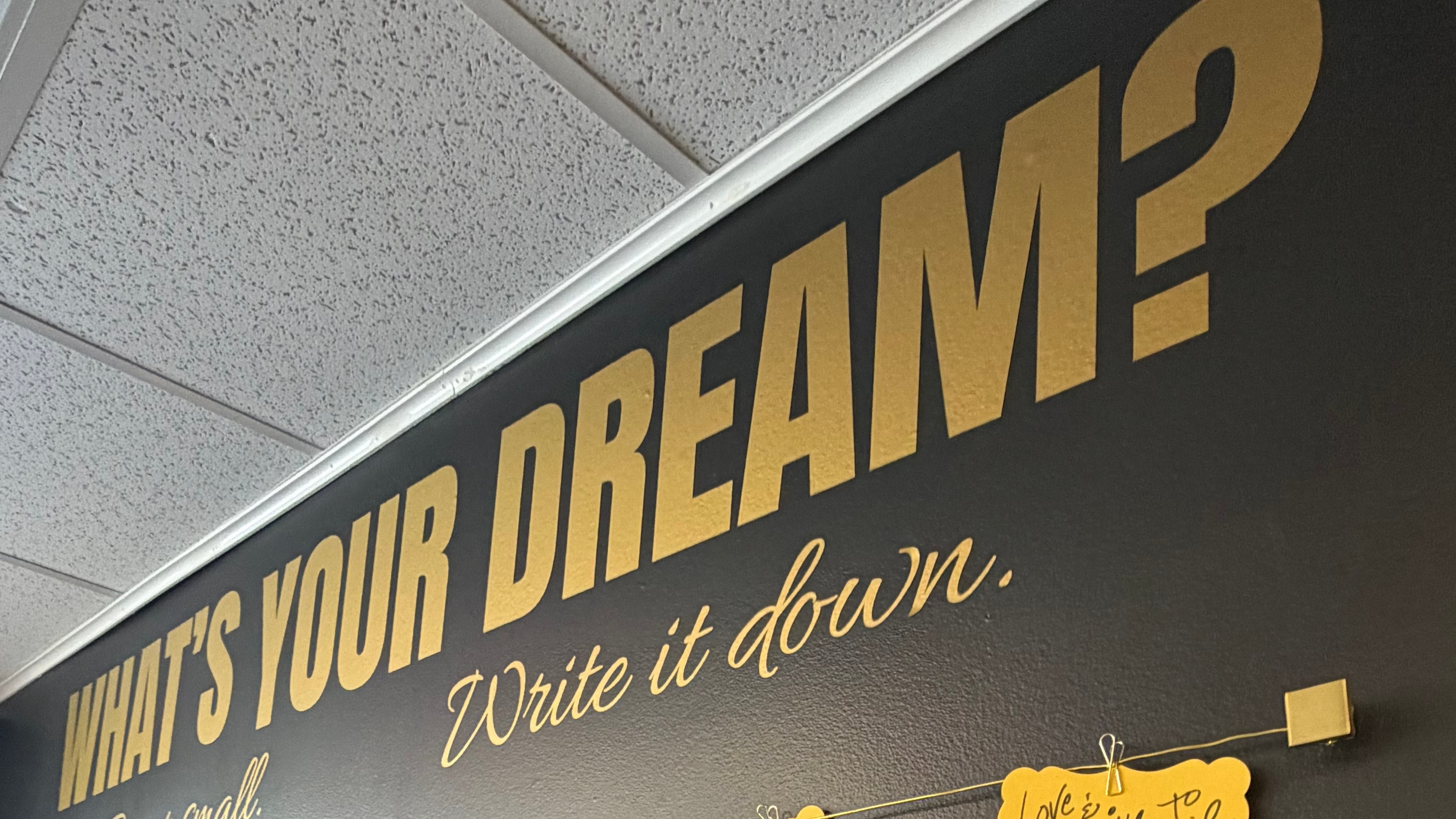 Wall with 'What's Your Dream?' prompt and yellow sticky notes attached